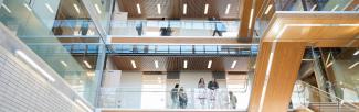 Students walking around in a multi-story UBC building
