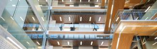 Students walking around in a multi-story UBC building