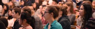 Students in a math classroom listen to a lecture