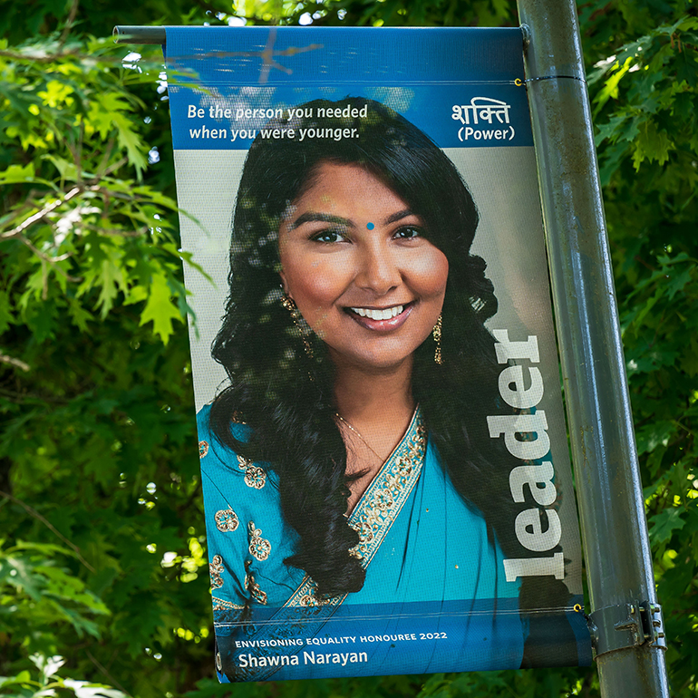 Shawna Narayan, pictured on a blue banner